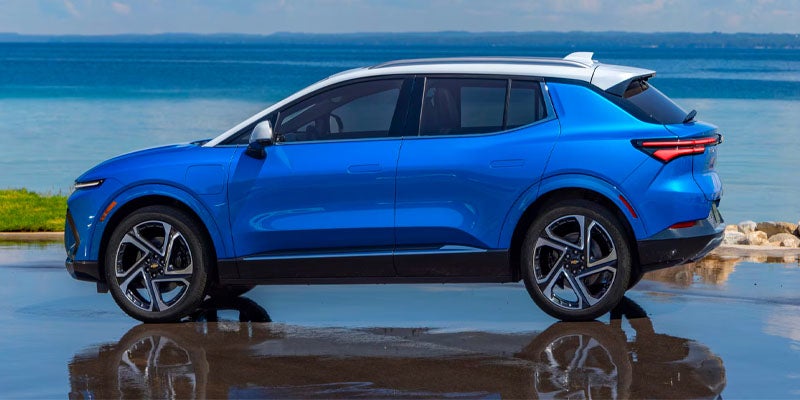 Blue 2025 Chevrolet Equinox EV with ocean in background
