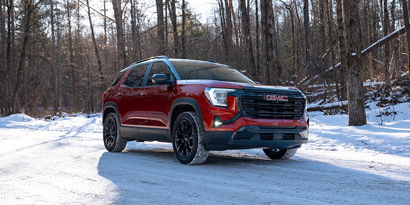 red GMC Terrain running on icy road